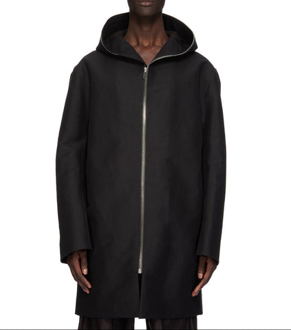 Man wearing a black hooded coat on a white background