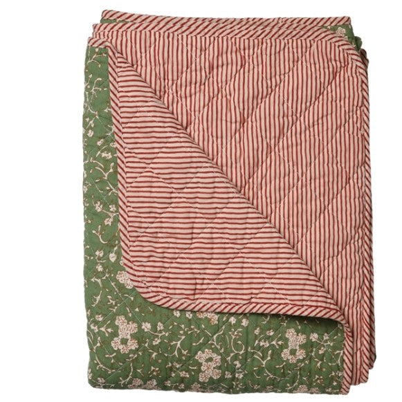 Folded fabric with pink and green patterns on a white background