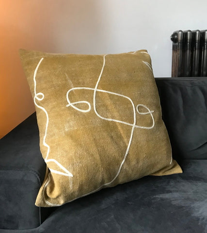 Embroidered ochre cushion