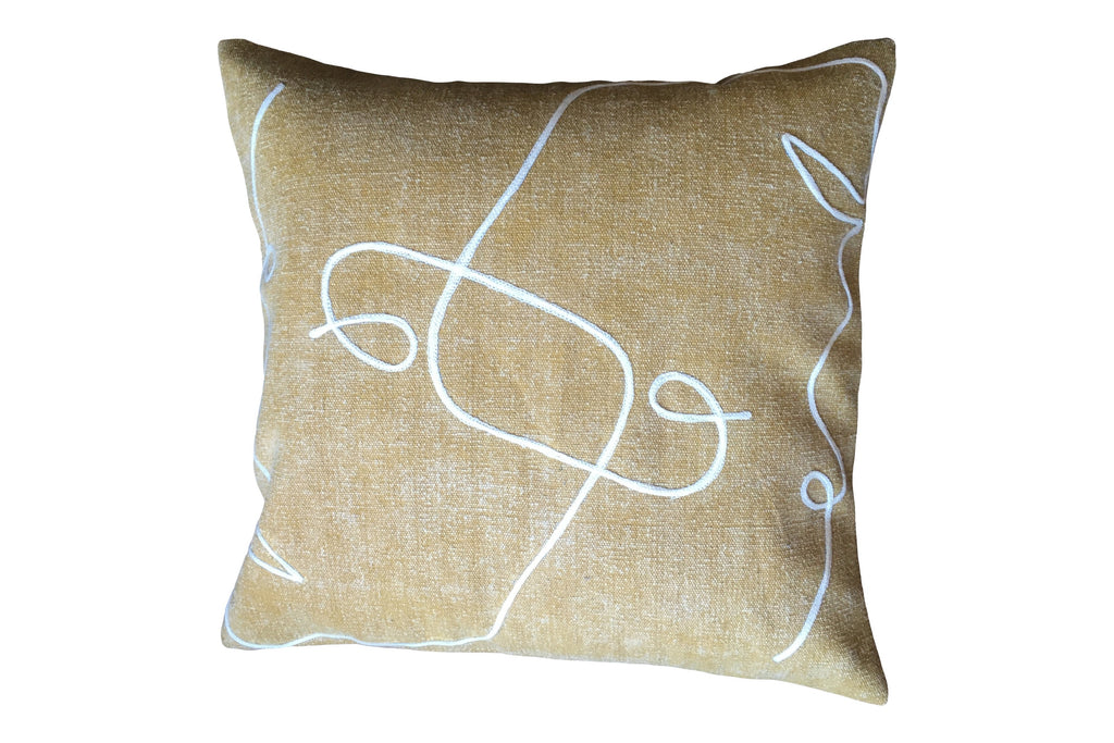 Embroidered ochre cushion